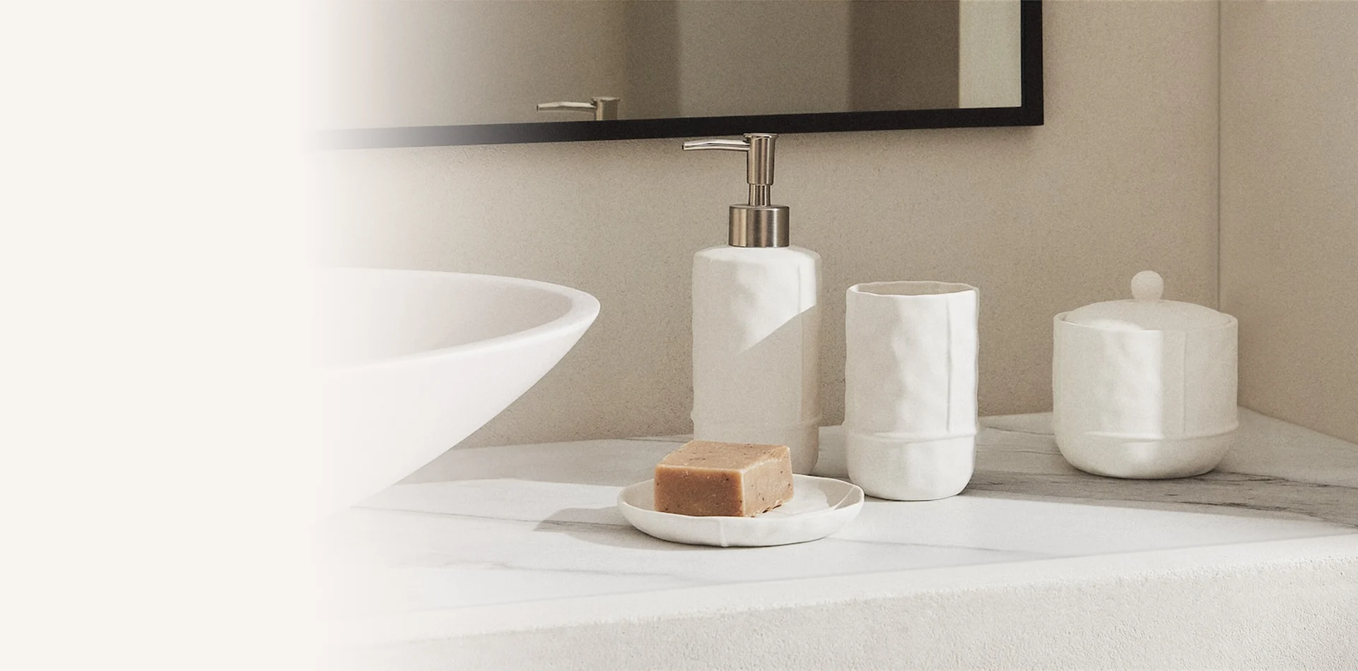 White bathroom accessories arranged beside a basin