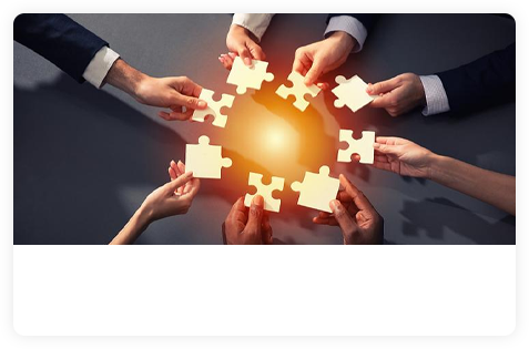A team bringing illuminated puzzle pieces together